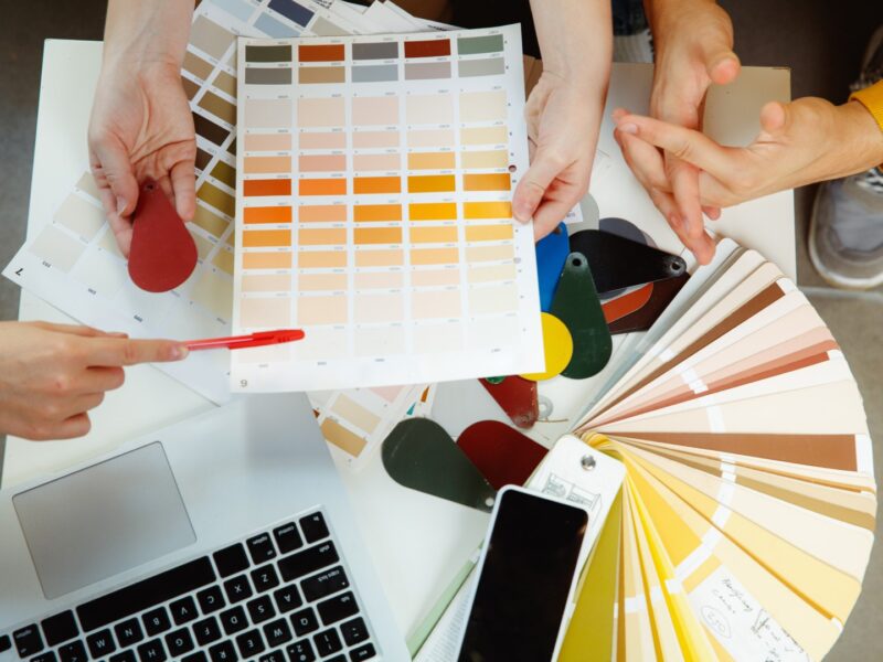 Interior designer working with young couple. Lovely family and professional designer or architector. Interior designer working with young couple. Lovely family and professional designer or architector discussing conept of future interior, working with colour palette, room drawings in modern office.